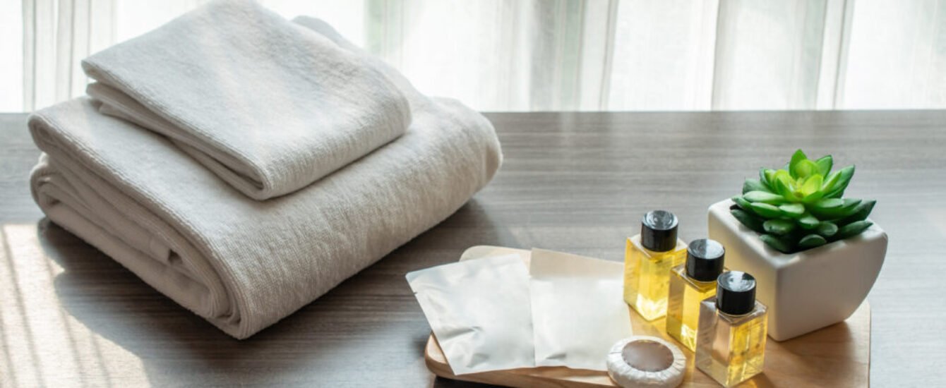 Set of hotel amenities (such as towels, shampoo, soap etc) on th