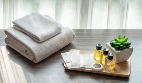 Set of hotel amenities (such as towels, shampoo, soap etc) on th